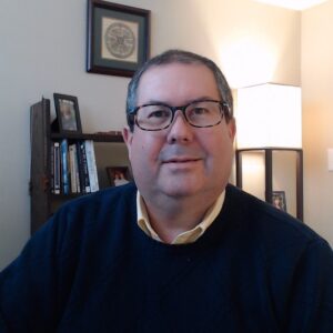 A photo of Gordon Brewer is captured. He is a therapist, consultant, podcaster and writer. Gordon is featured on Faith in Practice, a therapist podcast.