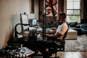 Picture of man podcasting representing podcast equipment needed for private practice