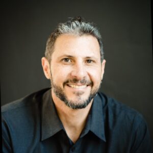 Image of Eric Malzone who is featured in this therapist podcast, speaking to Joe Sanok about making big scary business decisions