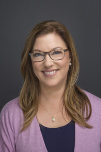 A photo of Lisa Wolcott is captured. Lisa is a psychotherapist and Group Practice owner of Wolcott Counseling. She is featured on Grow a Group, a therapist podcast.
