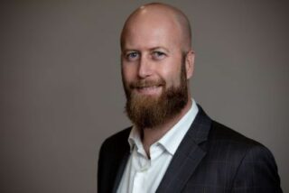 A photo of Fletcher Wimbush is captured. Hr is the CEO of The Hire Talent. Fletcher is featured on the Practice of the Practice, a therapist podcast. 